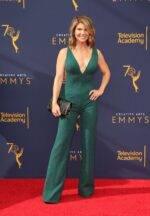 model wearing Jovani 60017 in green with a V-neckline and flared pants