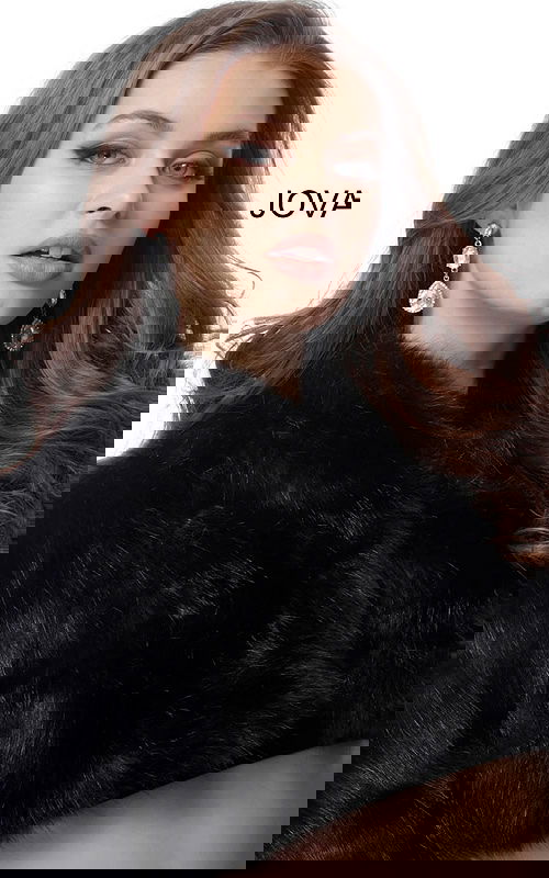 Model wearing Jovani M50165 elegant black dress front view.