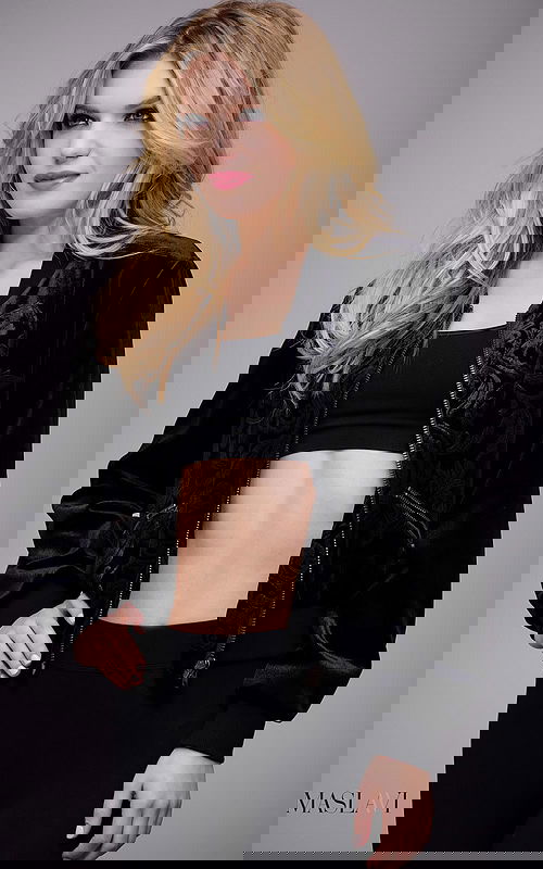 Model wearing M51285 black velvet jacket with floral embroidery from the front.