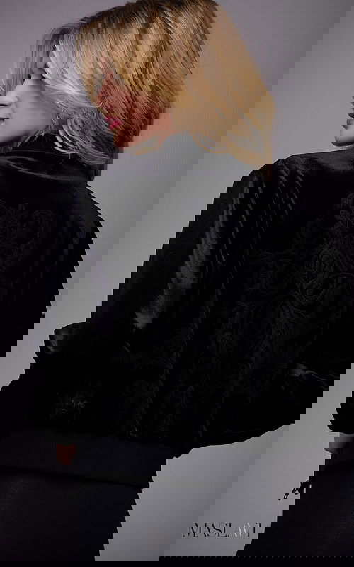 Model wearing M51285 black velvet jacket with floral embroidery from the back.