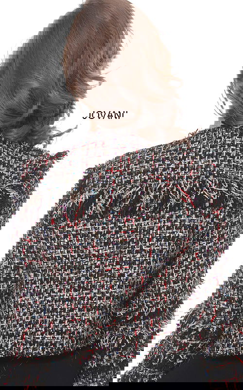 Back view of model wearing Jovani M61374 jacket showing textured fabric.