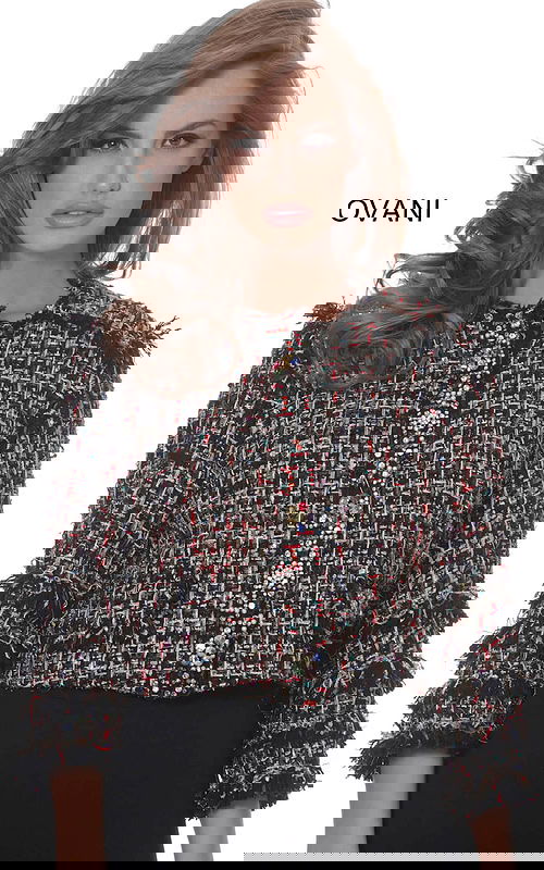 Model wearing Jovani M61374 jacket with multi-colored texture and sparkling details from the front.