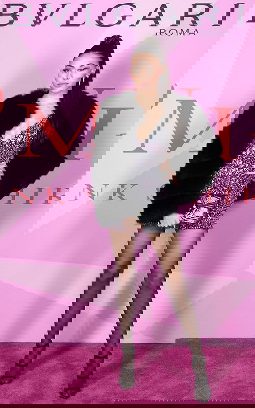 Model wearing Jovani 45060 silver mini dress with V-neckline at BVLGARI event.