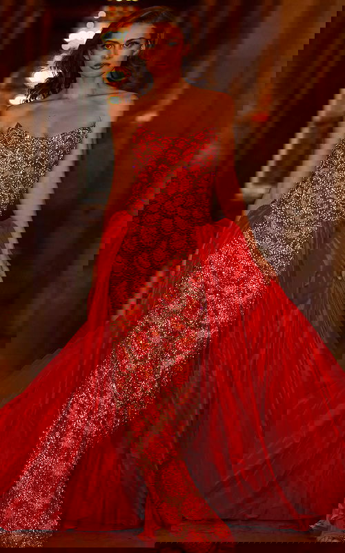 Model wearing S04603 vibrant orange gown with intricate beading and a strapless neckline.