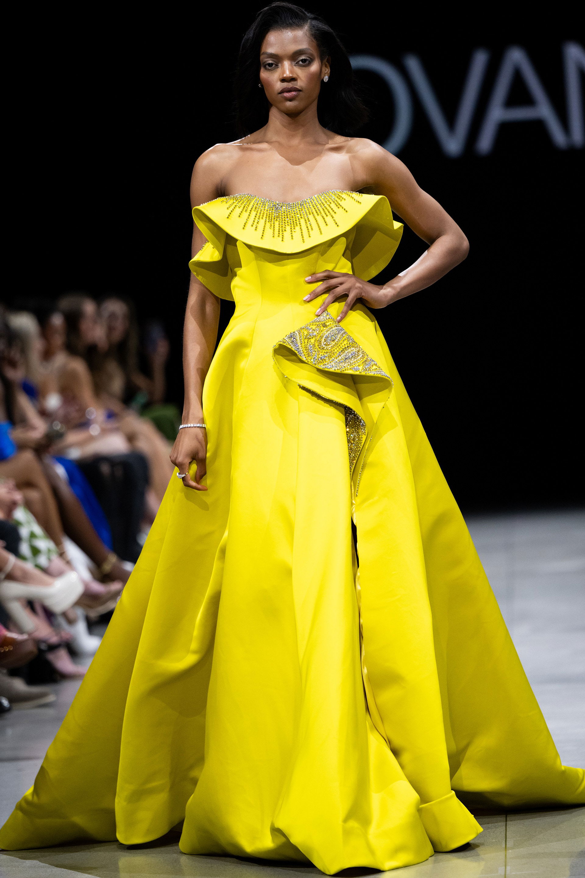 S36369.jpg Model wearing Jovani S36369 yellow gown with off-the-shoulder neckline and beaded detail
