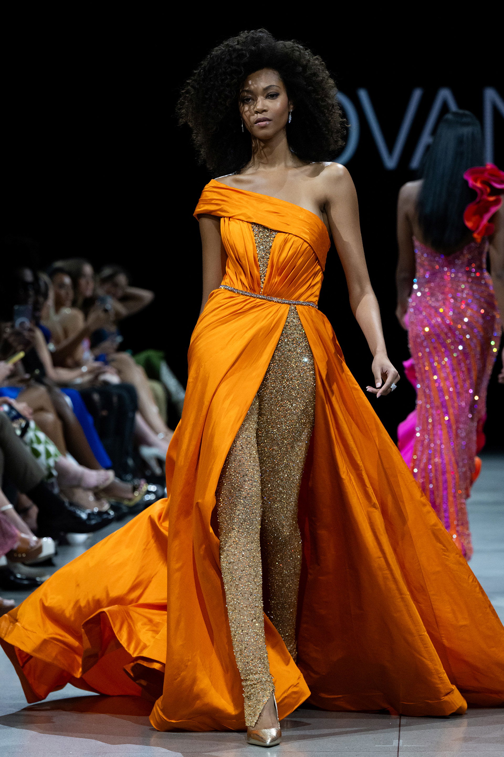 S38441.jpg Model wearing S38441 orange gown with off-the-shoulder neckline and high slit