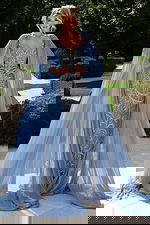 Blue embellished gown with cape sleeves and form-fitting silhouette