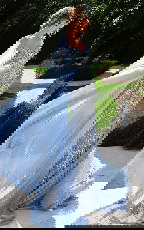 Elegant gown featuring crystal embroidery and flowing chiffon cape