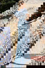 Light blue embellished dress featuring structured sleeves and high slit