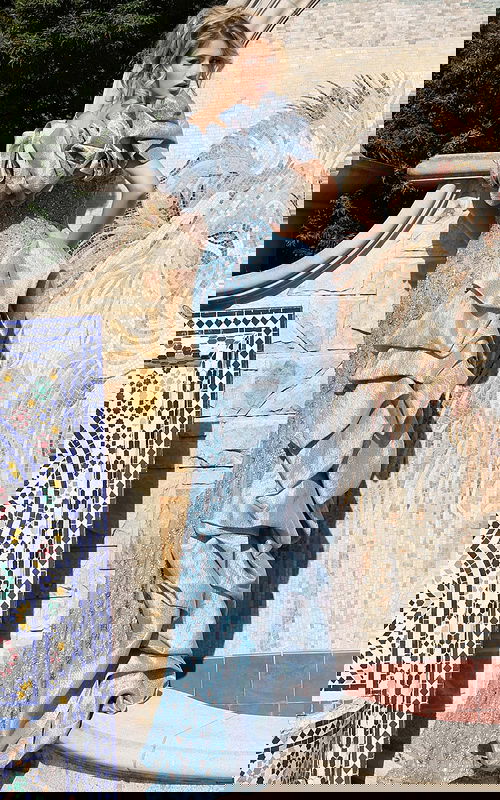 Light blue embellished dress featuring structured sleeves and high slit