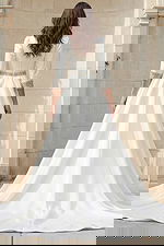 Back view of a long sleeve A-line wedding gown with beaded belt and crystal cuff details.