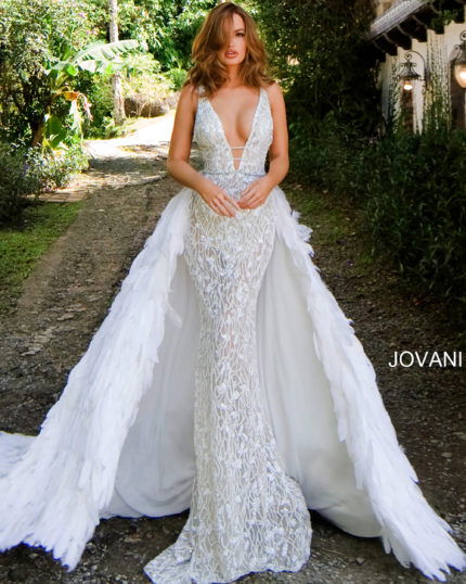 Model wearing Jovani S62942 white gown with mermaid silhouette and feather overlay.