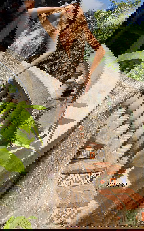 Model wearing Jovani S67085 nude gown with a plunging V-neckline and detailed embellishments.