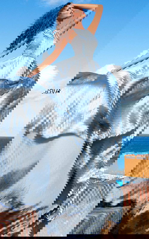 Model wearing Jovani S68289 silver gown with a halter neckline and embellished bodice.