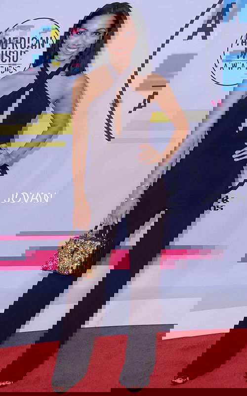 Model wearing Jovani 50908 dress with a halter neckline and keyhole cutout, full-length in purple.