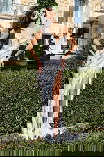 Model wearing strapless sequin gown with thigh-high slit and sweetheart neckline