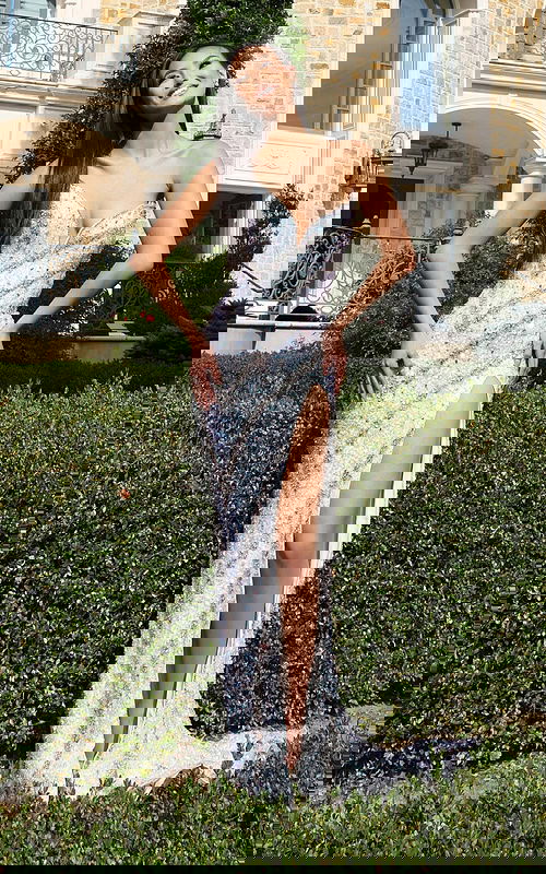 Model wearing strapless sequin gown with thigh-high slit and sweetheart neckline