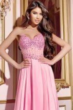 Model posing in Jovani D6021 pink gown showcasing beaded details.