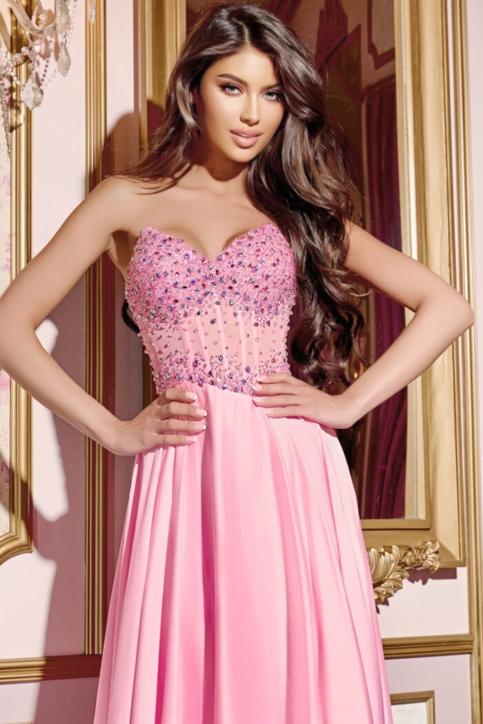 Model posing in Jovani D6021 pink gown showcasing beaded details.