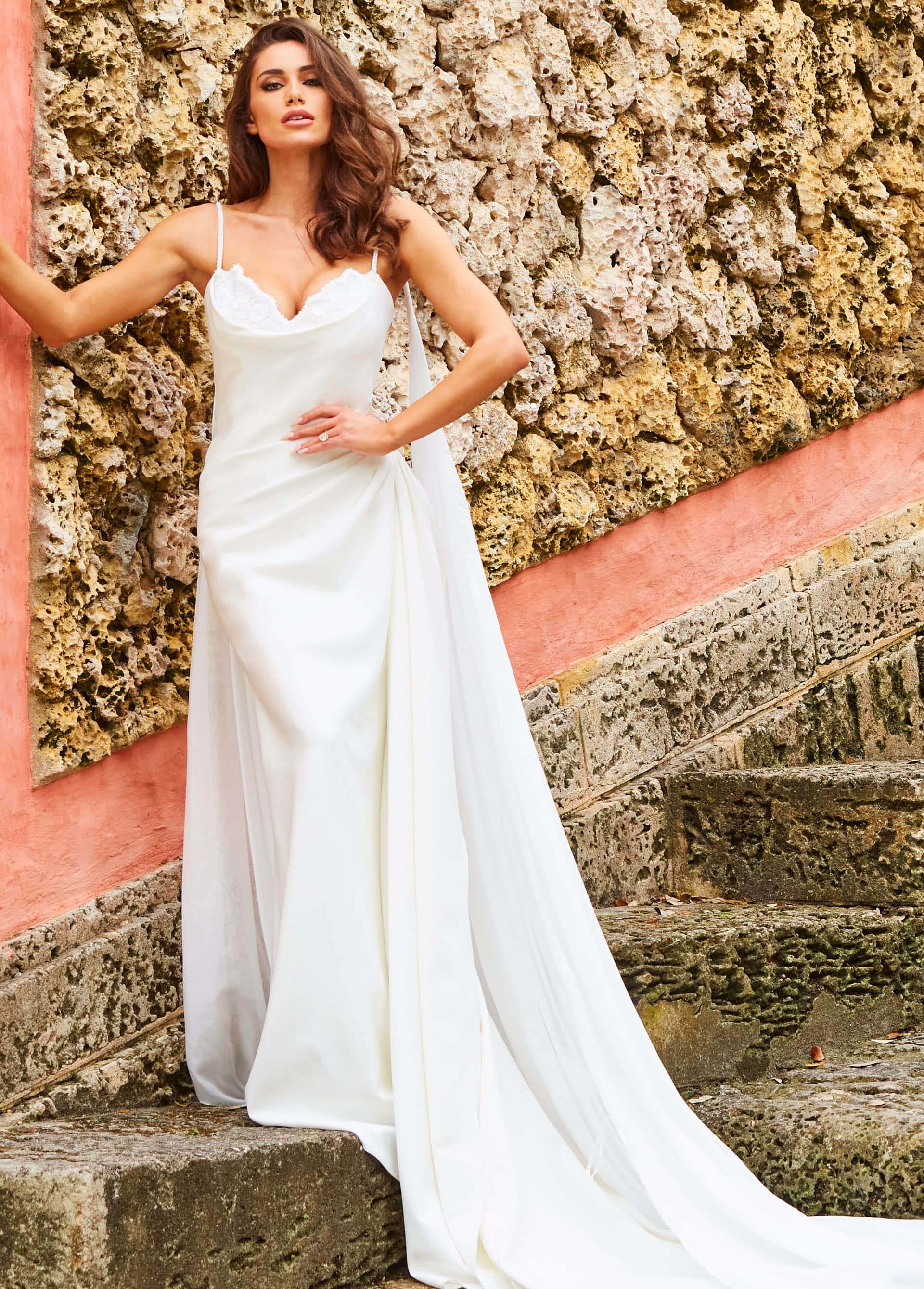 jb07139-ivory-wedding-dress.jpg Model wearing Jovani JB07139 white gown with scoop neckline and flowing train, front view.