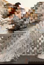 Back view of brocade wedding gown with oversized bow and flowing train