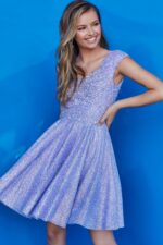 Model wearing Jovani K04446 lilac dress with V-neckline and cap sleeves, posing front view.