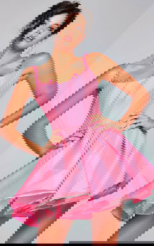 model wearing Jovani k44210 pink dress with flared silhouette and decorative neckline