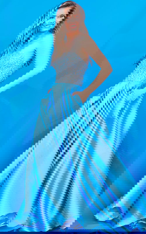 Model wearing Jovani K66689 elegant blue gown with embellishments