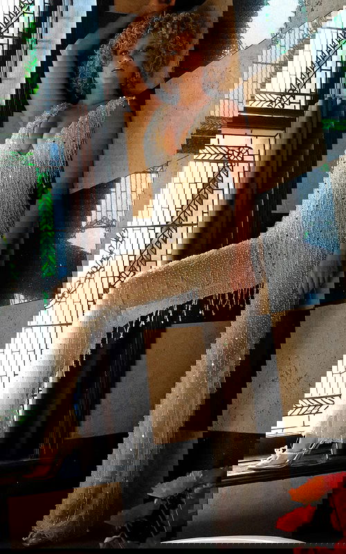 Model wearing Jovani 32592 nude jumpsuit with fringe detail.