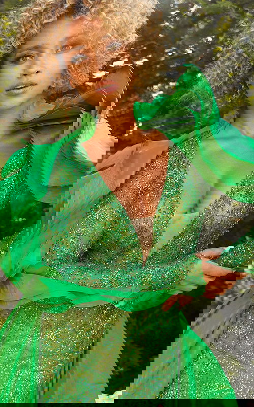 Model showcasing details of Jovani S09554 green dress with embellished V-neckline.