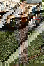 Model wearing long sleeve beaded gown with high slit and open back S05821