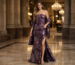 Strapless plum brocade gown in luxury hotel lobby